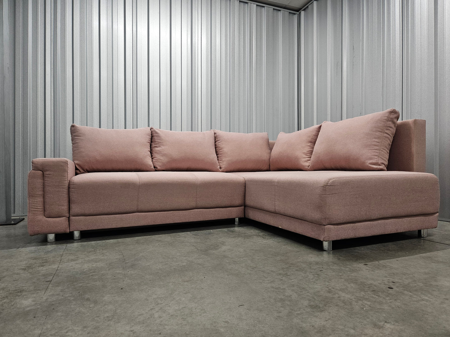 Modern L-shaped sofa in elegant blush pink upholstery