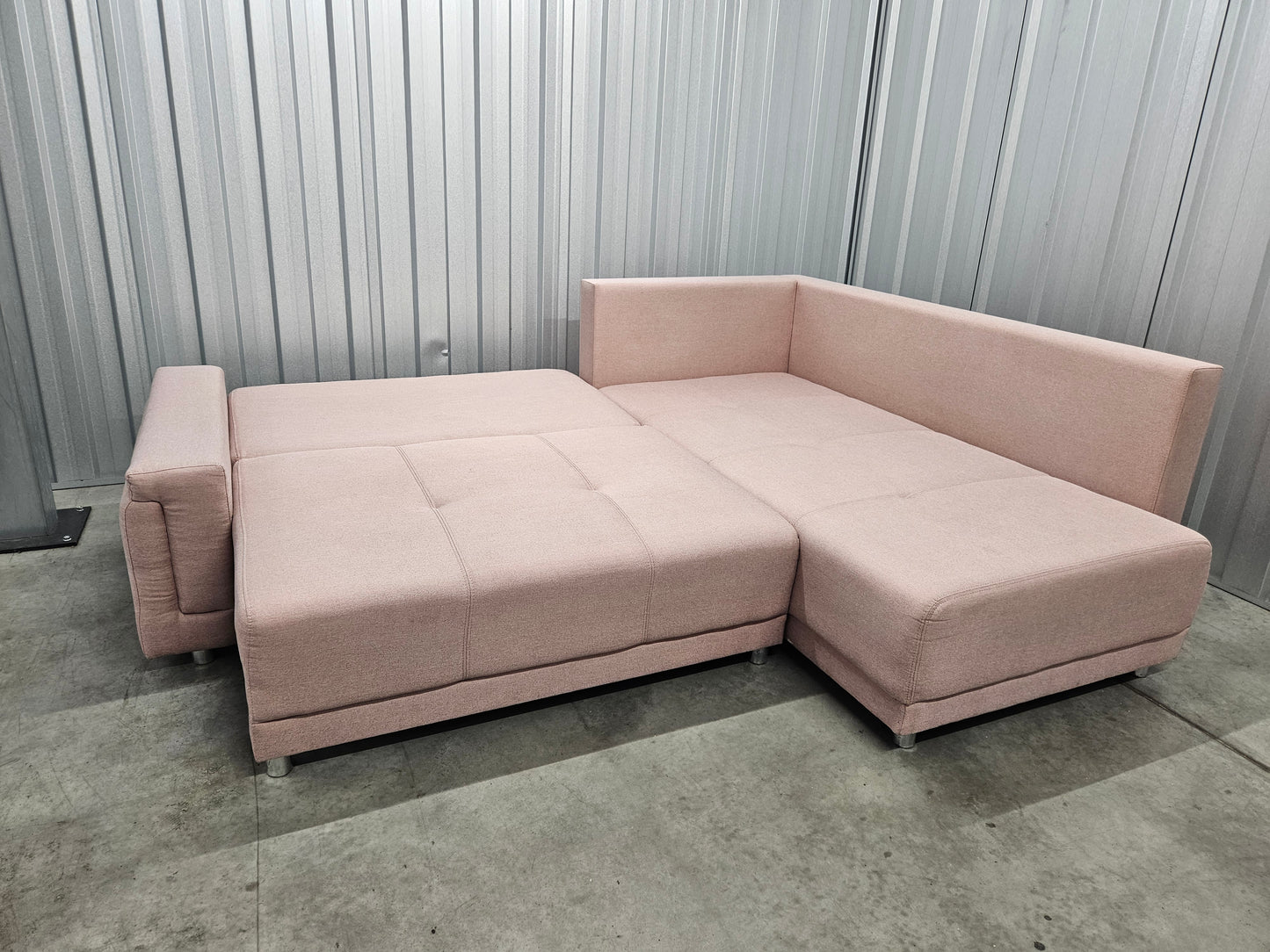 Modern L-shaped sofa in elegant blush pink upholstery