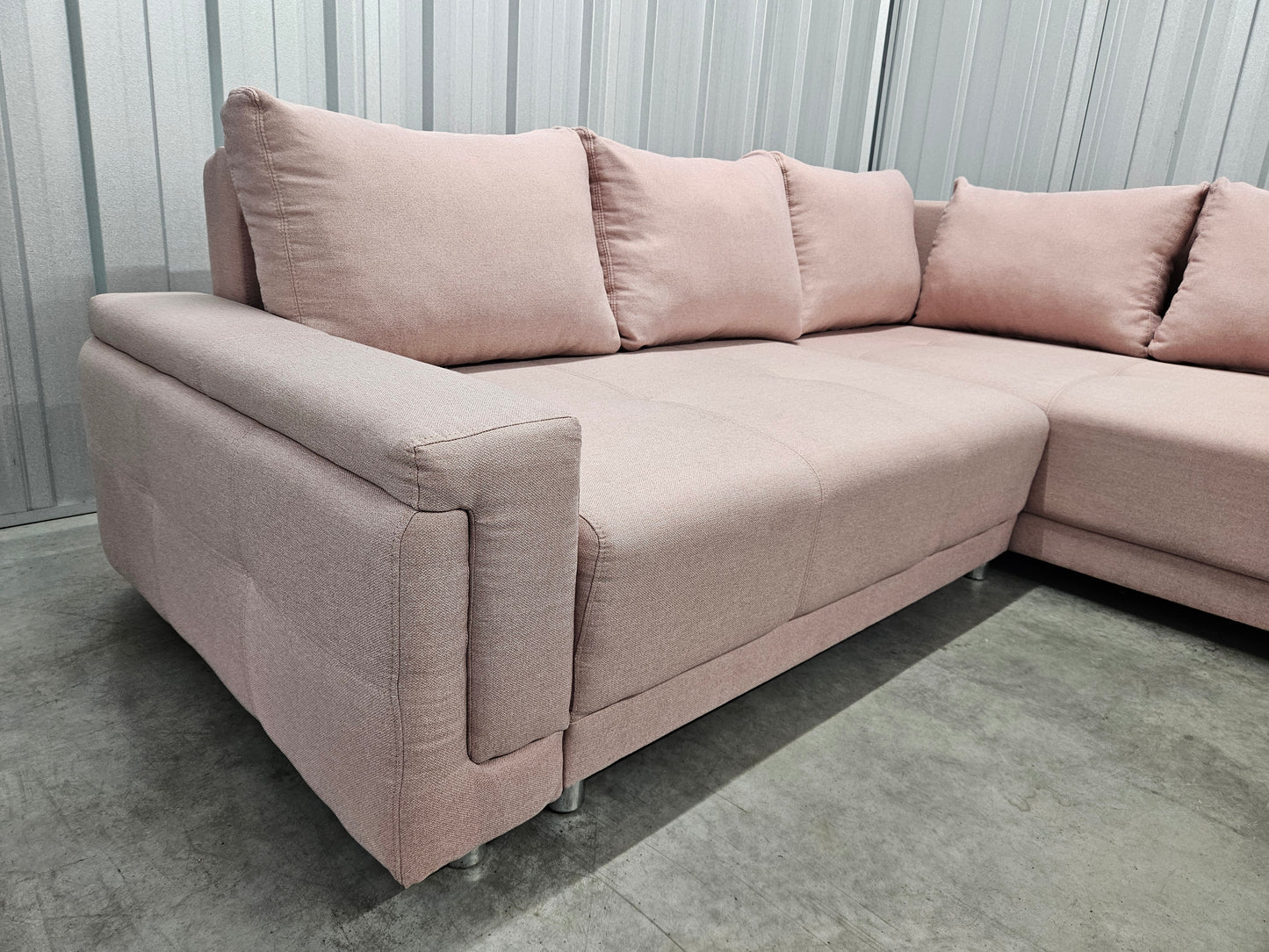 Modern L-shaped sofa in elegant blush pink upholstery