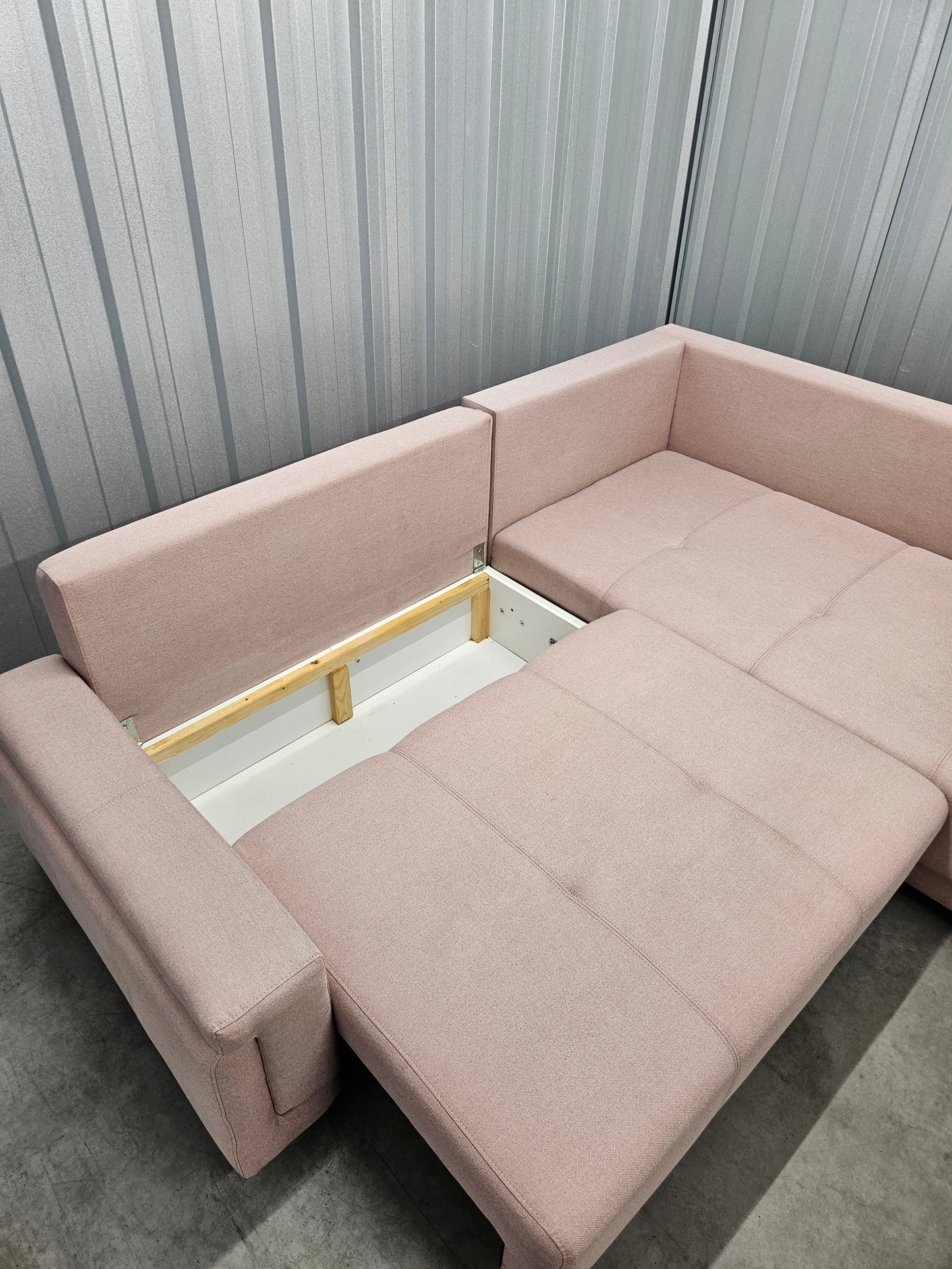 Modern L-shaped sofa in elegant blush pink upholstery