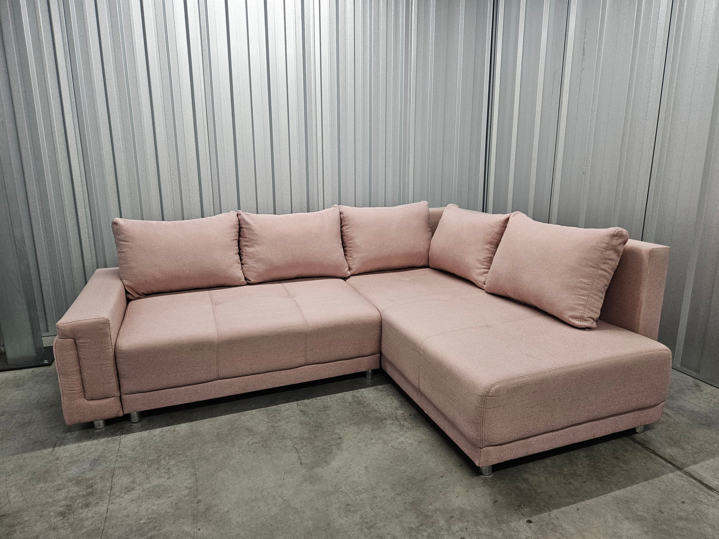 Modern L-shaped sofa in elegant blush pink upholstery