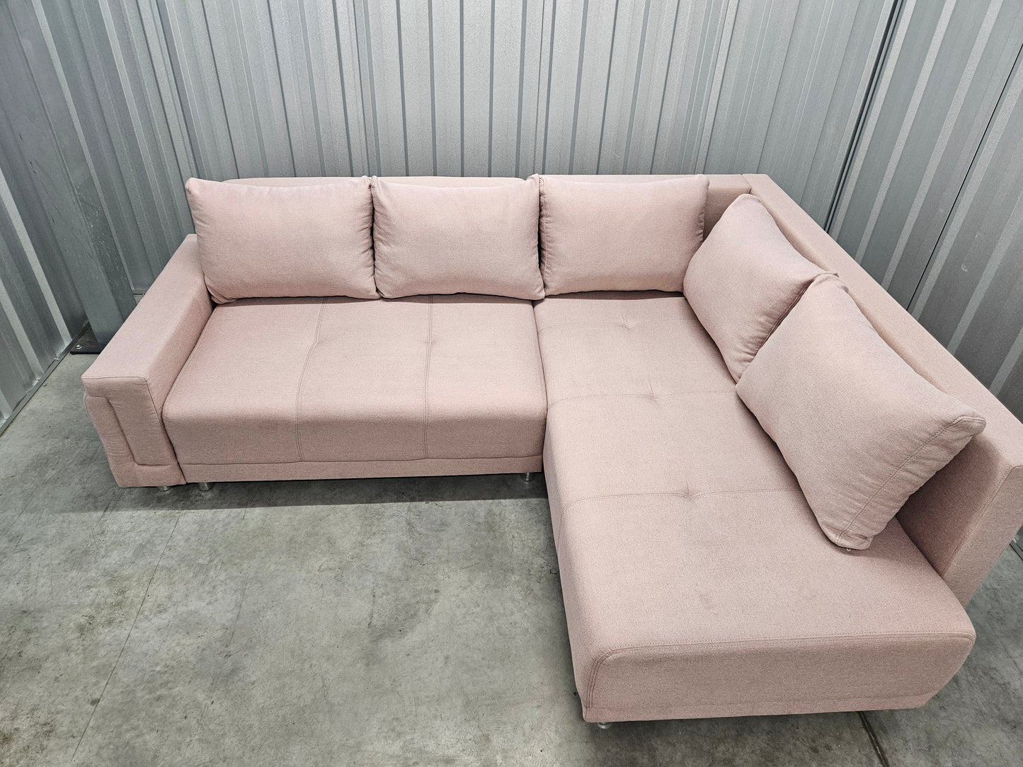 Modern L-shaped sofa in elegant blush pink upholstery