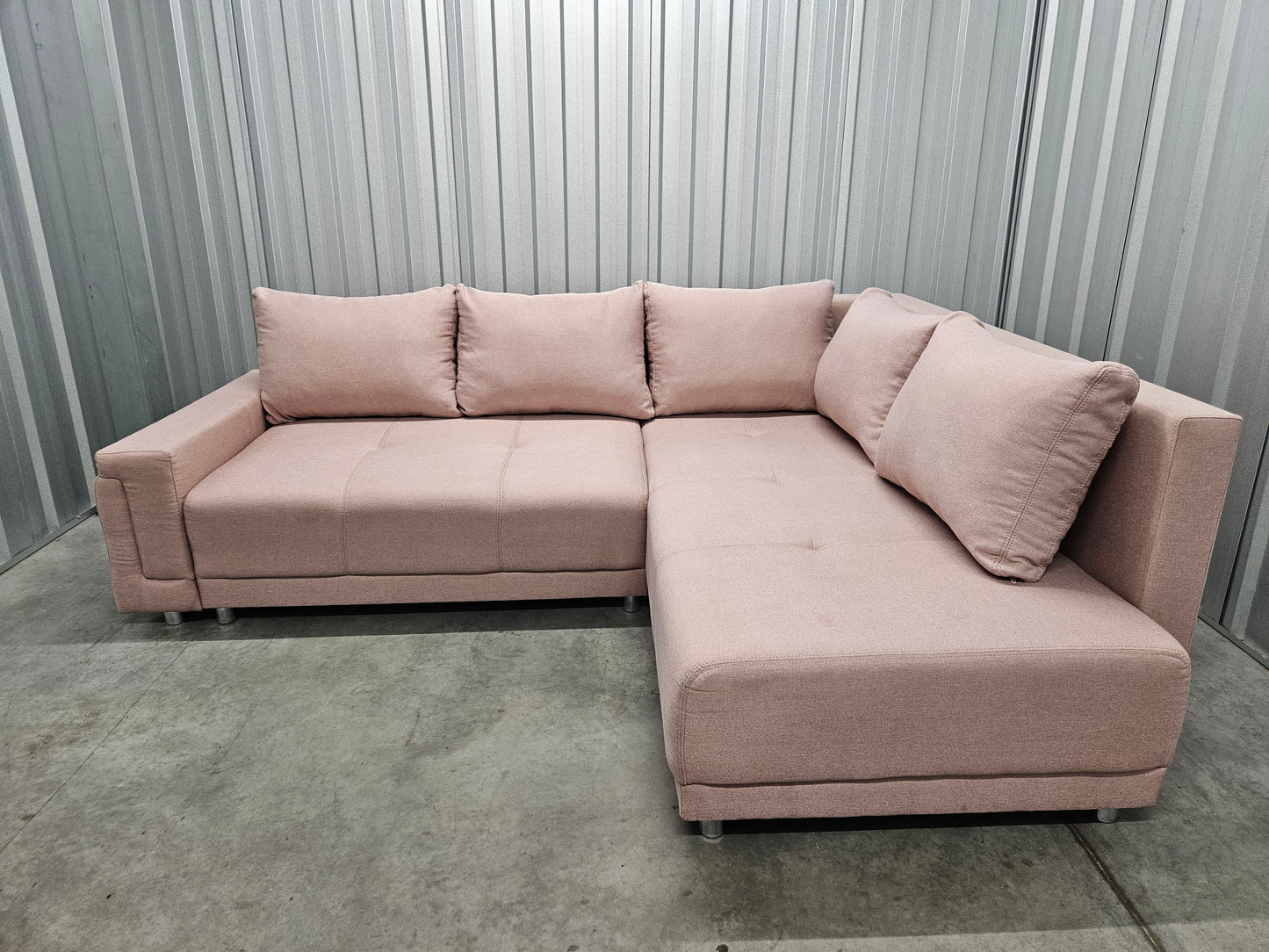 Modern L-shaped sofa in elegant blush pink upholstery