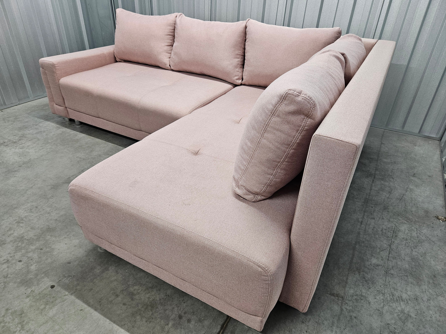 Modern L-shaped sofa in elegant blush pink upholstery