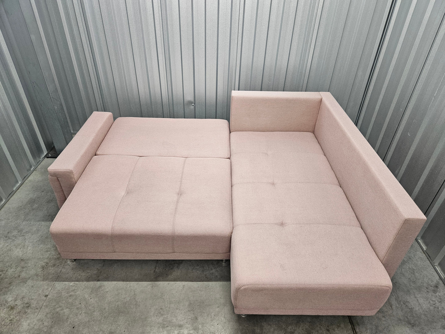 Modern L-shaped sofa in elegant blush pink upholstery
