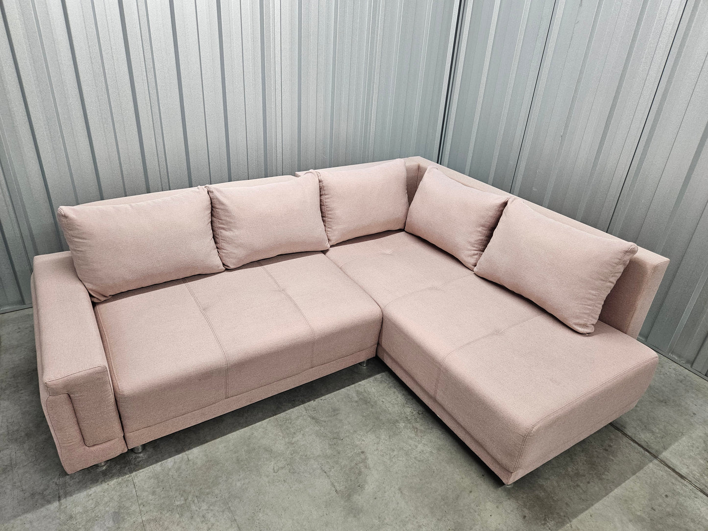 Modern L-shaped sofa in elegant blush pink upholstery
